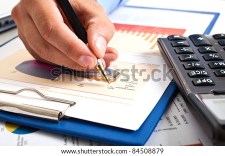 Closeup of a businessman's hands while writing some documents