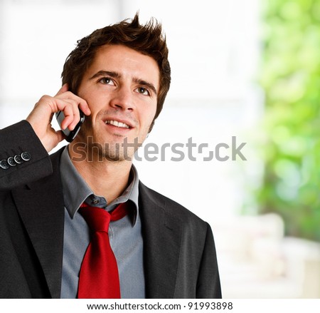 Portrait of a smiling businessman speaking on the phone