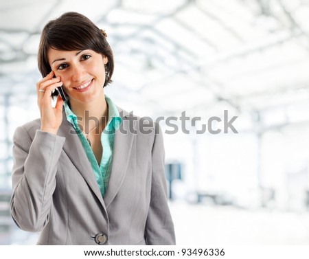 Portrait of a young beautiful businesswoman speaking at phone