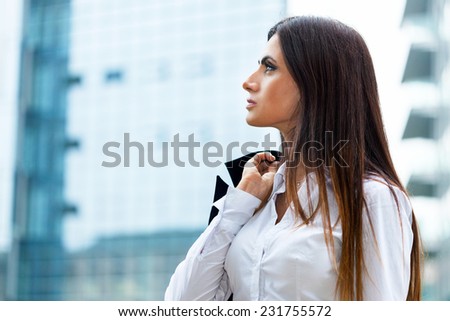 Portrait of a woman holding a jacket on her shoulder