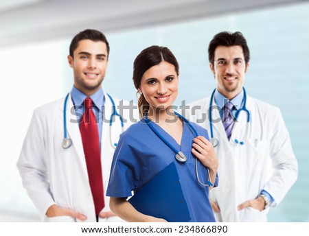 Portrait of a smiling nurse in front of her medical team