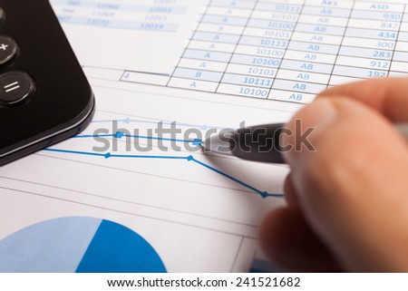 Business scene: man writing on a business document