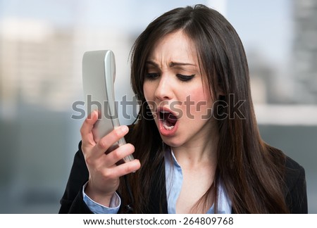 Portrait of an angry businesswoman yelling at phone