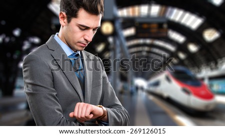 Man waiting for the train to arrive in a railroad station
