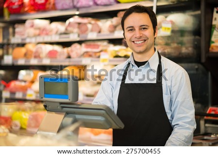 Portrait of a smiling shopkeeper in a grocery store