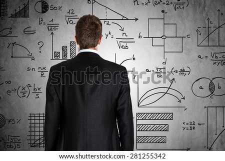 Businessman in front of math formulas