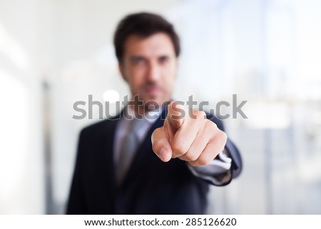 Portrait of a businessman pointing his finger to you