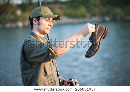 Portrait of a fisherman fishing on a river