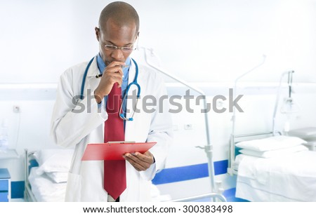 Portrait of a doctor reading a case history