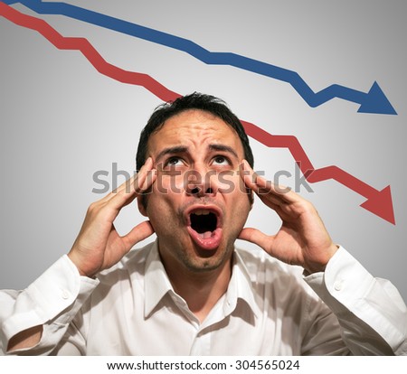 Desperate man in front of falling arrows, financial crisis concept