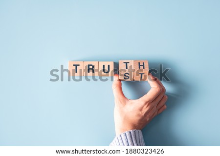 Hand turned wood cube and changes the word 'Trust' to 'Truth'. Сток-фото © 