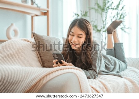 Similar – Image, Stock Photo Happy Asian woman browsing smartphone near car