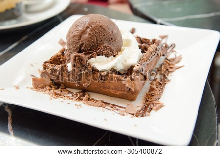 Chocolate waffle with ice cream and whip cream soft focus
