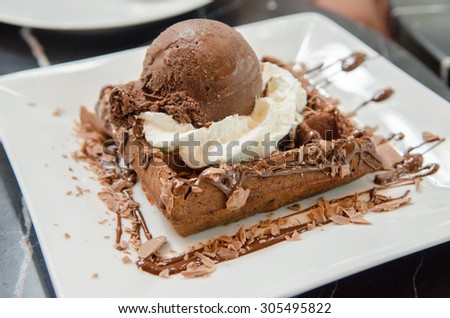 Chocolate waffle with ice cream and whip cream