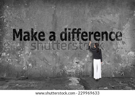 businesswoman drawing make a difference on the wall