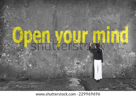 businesswoman drawing open your mind on the wall