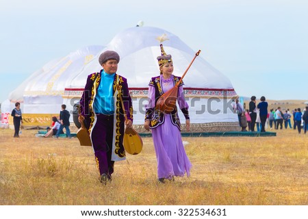 KAZAKHSTAN, KARKARALINSK - SEPTEMBER, 6, 2014: Artists in kazakh national costumes and dombras at Karkaralinsk 190 years universary celebrating