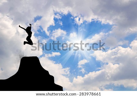 Concept of success. Silhouette of a man jumping with their hands up against a background of the sunny sky in the clouds. design element