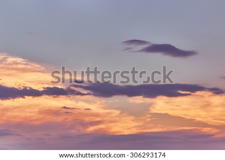 Beautiful cloudy evening sky with sun rays with purple tinge