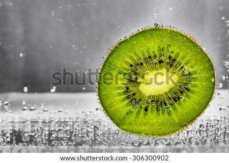Kiwi slices in water with bubbles of gas. design element