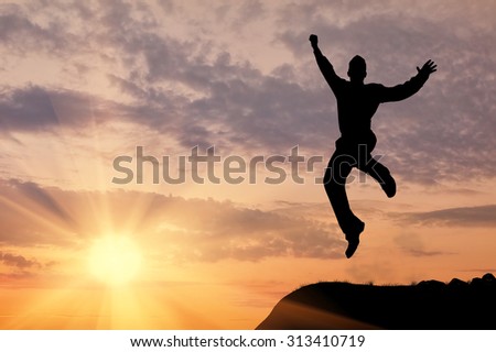 Business concept. Silhouette of a man jumping in the sunset