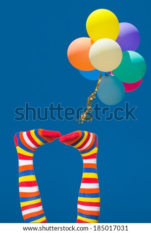 Summer joy, summer vacation concept. Funny legs on blue sky and balloons. focus on legs