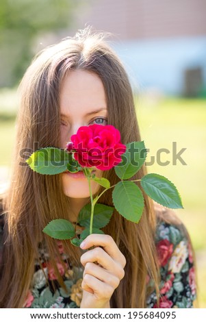 Sad woman with a flower hide her face, focus on eyes