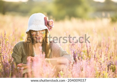 Romantic woman in summer field paints and enjoy nature on a sunny summer day