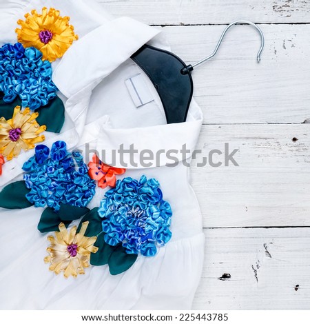 Silk flower embroidery on white blouse. Summer concept