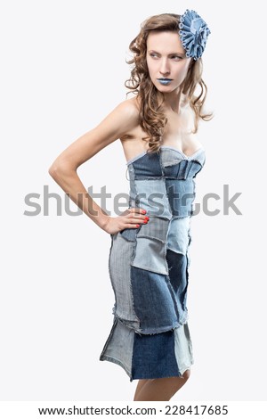 Sexy young woman in a trendy clothes on white. Recycle fashion