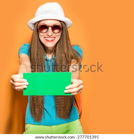 Happy hipster traveler woman with boarding card over vibrant background, focus on face