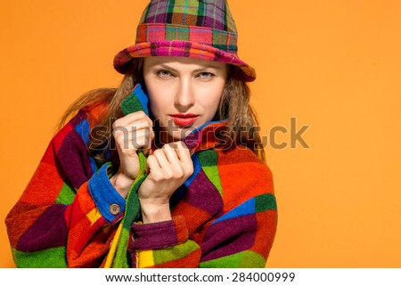 Autumn fashion woman over bright orange background
