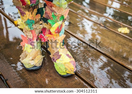 Autumn fashion. Female legs in autumn shoes boots, outdoors shot