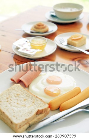 fried eggs, bread and sausage in breakfast set