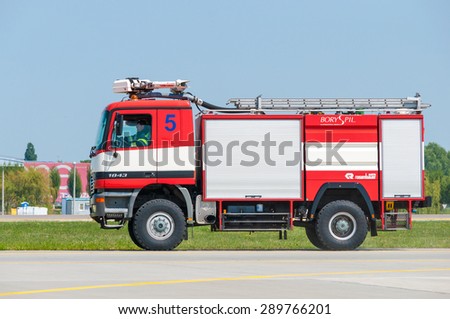 BORYSPIL, UKRAINE - MAY, 20, 2015: Red firetruck Mercedes Benz ride on call fire suppression and mine victim assistance at Boryspil International Airport, Kiev, Ukraine.