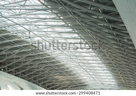 metal and glass roof of a huge empty hangar.architecture detail.
