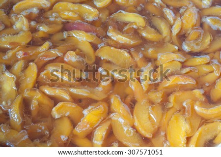 Making apricot jam. Apricot slices cooking before conservation. Summer fruit background.