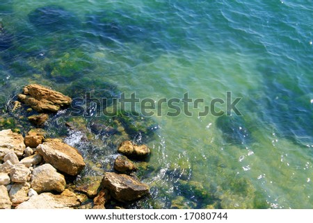 Rocks under the waves.Cool background with lots of space for text.