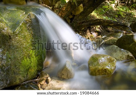 Water stream  falling on a rock.Long exposure is used.