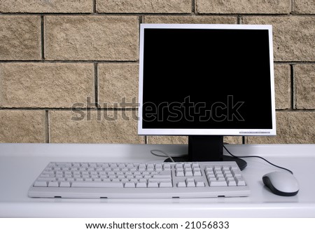 PC with black desktop and brick wall background