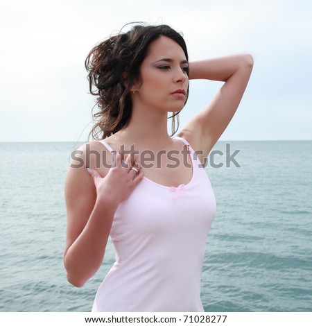 Gorgeous beautiful woman with clear blue sea and sky at background