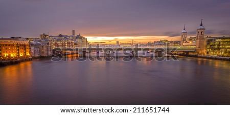 Panorama of London from London Bridge at Sunset hour with very intense golden hour.