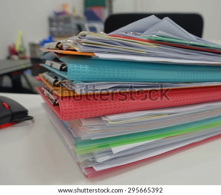 Stack of many color document folder on desk at office.