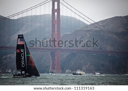 SAN FRANCISCO, CALIFORNIA, USA - AUGUST 25, 2012: Team USA sails past Golden Gate Bridge in the America\'s Cup Louis Vuitton Cup Sailing races on August 25, 2012 in San Francisco Bay, California