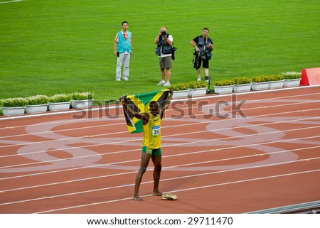 BEIJING - AUG 18: Usain Bolt celebrates holding the Jamaican flag after setting new world record  for men\'s 100 meter sprint at the 2008 Olympic. August 18, 2008 Beijing, China