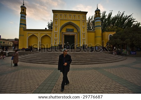 KASHGAR, CHINA - OCT 2 :  A Uyghur man walks in front of Id Kah Mosque on the last day of Ramadan October 2, 2008 in Kashgar, Xinjiang province western China.