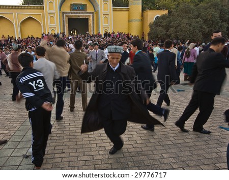 KASHGAR, CHINA - OCT 2 : Uyghur men dance outside Id Kah Mosque after service at the end of Ramadan October 2, 2008 in Kashgar, Xinjiang province western China.