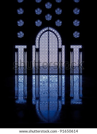 Blue light reflects off marble floor from illuminated stained glass windows framing doorway into mosque in Casablanca, Morocco