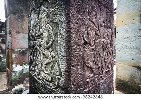 SIEM REAP, CAMBODIA: Ancient carvings of apsara dancing woman take on different colors as the ruins of Angkor Wat age.