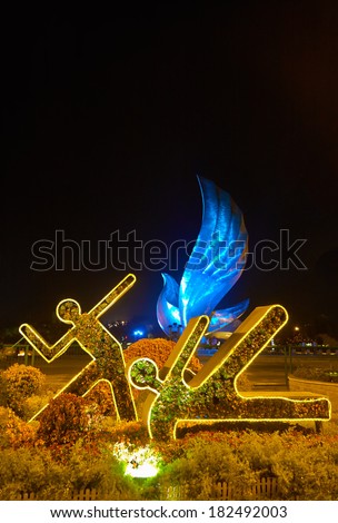 QINHUANGDAO, CHINA - SEPTEMBER 01: Dove of Peace Sculpture and flower bed in the form of athletes. Entrance to the Olympic Park, 2011